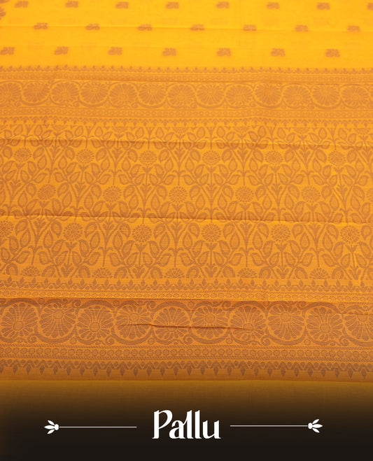 Saffron orange colour silk cotton saree featuring elegant grey floral and geometric woven motifs across the body, paired with a deep contrast grey border and pallu showcasing intricate traditional patterns & Comes with a matching blouse piece.