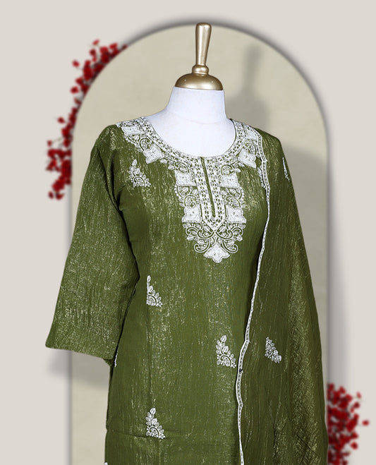 Green colour churidar set featuring elegant white thread embroidery on the neckline, sleeves, and scattered motifs across the body, Paired with a matching embroidered dupatta, this ensemble radiates graceful charm and festive appeal.