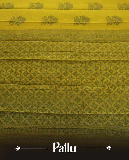 Olive green colour silk cotton saree featuring subtle woven motifs throughout the body, enhanced by a striking contrast border and an intricately designed pallu with floral patterns &  Comes with a matching blouse piece.