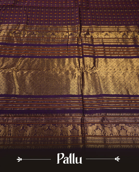 Navy blue Pure Kanchi cotton saree featuring all over checks with floral buttas, accentuated by a striking zari border woven with majestic elephant motifs, blending heritage charm with elegance.