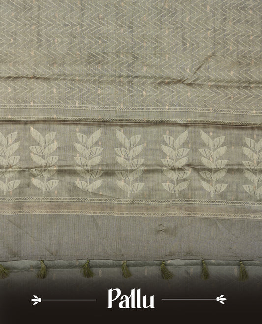 Olive sage colour semi tussar saree adorned with Cream Zigzag printed pattern across the body and Leaf pattern on contrast olive sage colour border, paired with a matching blouse.