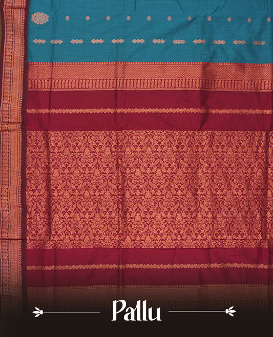 Blue colour Kalyani Cotton saree in deep maroon with golden floral motifs, paired with a contrasting maroon border featuring intricate zari work & Comes with a matching blouse piece.