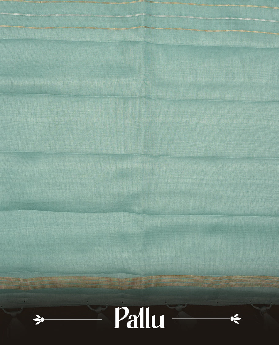 Pastel aqua colour semi tussar silk saree highlights gold and silver zari stripes across body,  border, pallu and paired with matching blouse piece.