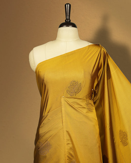 Deep mustard yellow colour semi soft silk saree, beautifully designed with woven leaf motifs & The look is enhanced by a rich contrast green pallu, paired with a matching blouse.