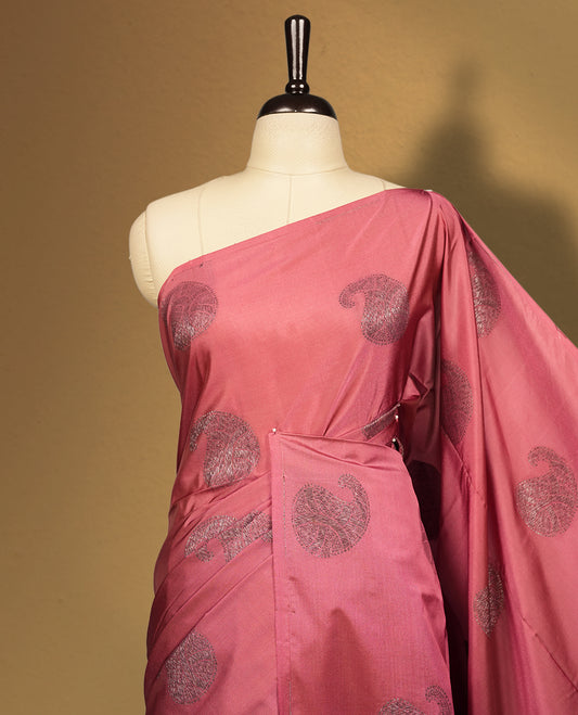 Cherry pink colour semi soft silk saree, adorned with subtle woven mango motifs on the body & The design is elevated with an elegant zari border and pallu, paired with a matching blouse.