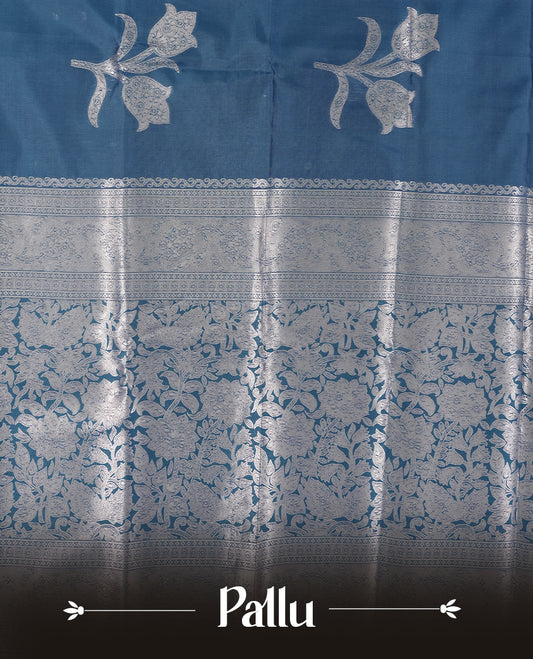 Teal Blue Semi Silk Saree with Silver Zari Floral Woven Pallu and Border, Subtle Zari Butta Motifs on the Body, Tassel Detailing, and Coordinated Blouse Piece