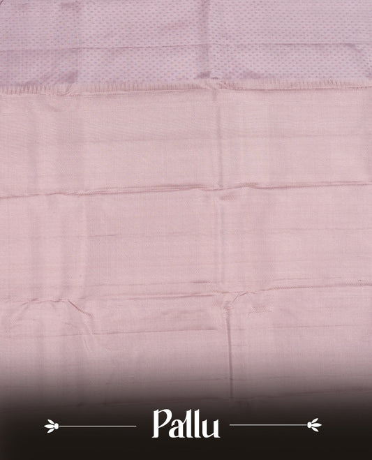 Dusty Lavender colour Vasundhara silk saree featuring self colour motifs across the body, finished with a self‑coloured tiny daimond pattern with gold tree motifs on border and a coordinating blouse.
