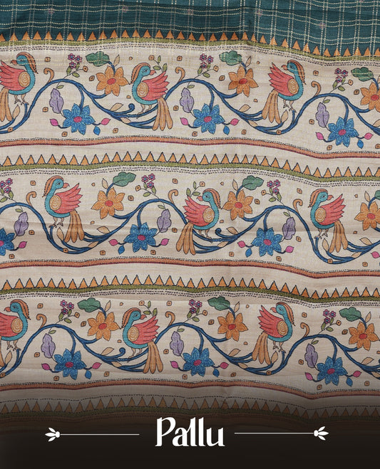 Dark green colour semi tusser silk saree featuring gold zari check pattern with floral butti motifs, with contrast floral kodi & bird pattern and paired with matching blouse.