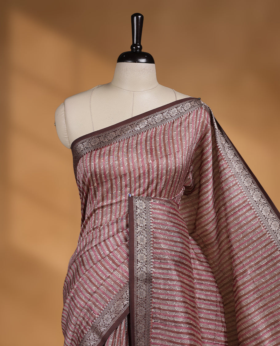 Cream colour chanderi silk saree with Brown& pink geometric stripped printed On body, compilmented by contrast chocolate brown colour border with golden zari floral pattern and a matching blouse.