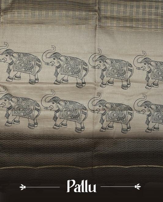 Green colour semi tusser silk saree featuring Gold zari check pattern across body, faded contrast cream colour border with elephant print and paired with matching blouse.