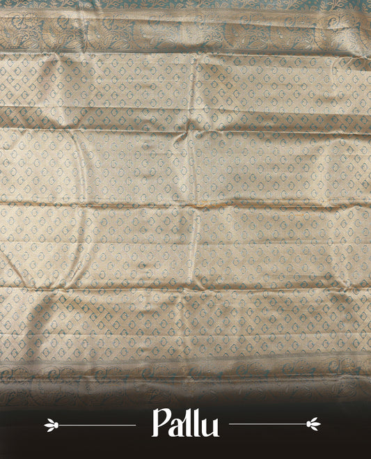 Blue colour tissue brocade saree with delicate floral and leaf motifs in antique gold zari work throughout body. Ornate gold border and pallu with traditional floral scrolls, navy blue accents. Includes coordinating blouse.