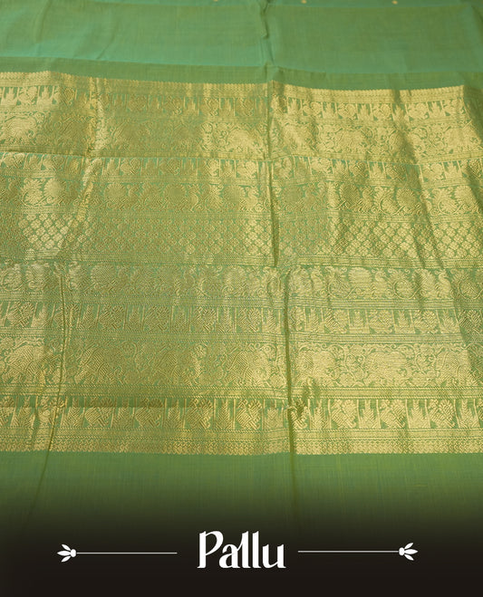 Fern Green colour Pure Kanchi cotton saree featuring delicate golden buttas and a rich zari border with intricate motifs & Paired with a matching blouse, it exudes timeless elegance, perfect for festive and traditional occasions.