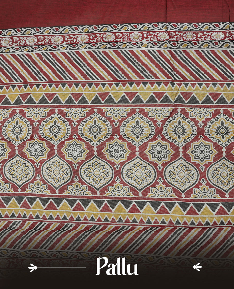 Maroon colour chanderi cotton saree with plain body, geometric tribal printed pallu with golden zari border, and diagonal striped blouse.