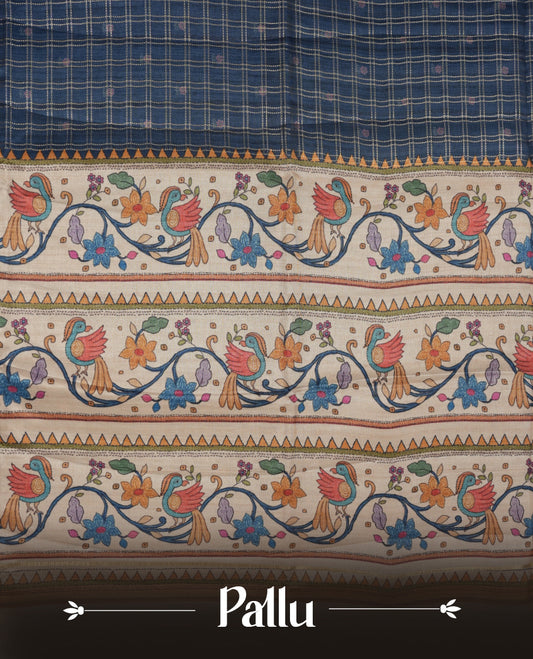 Dark blue colour semi tusser silk saree featuring gold zari check pattern with floral butti motifs, with contrast floral kodi & bird pattern and paired with matching blouse.