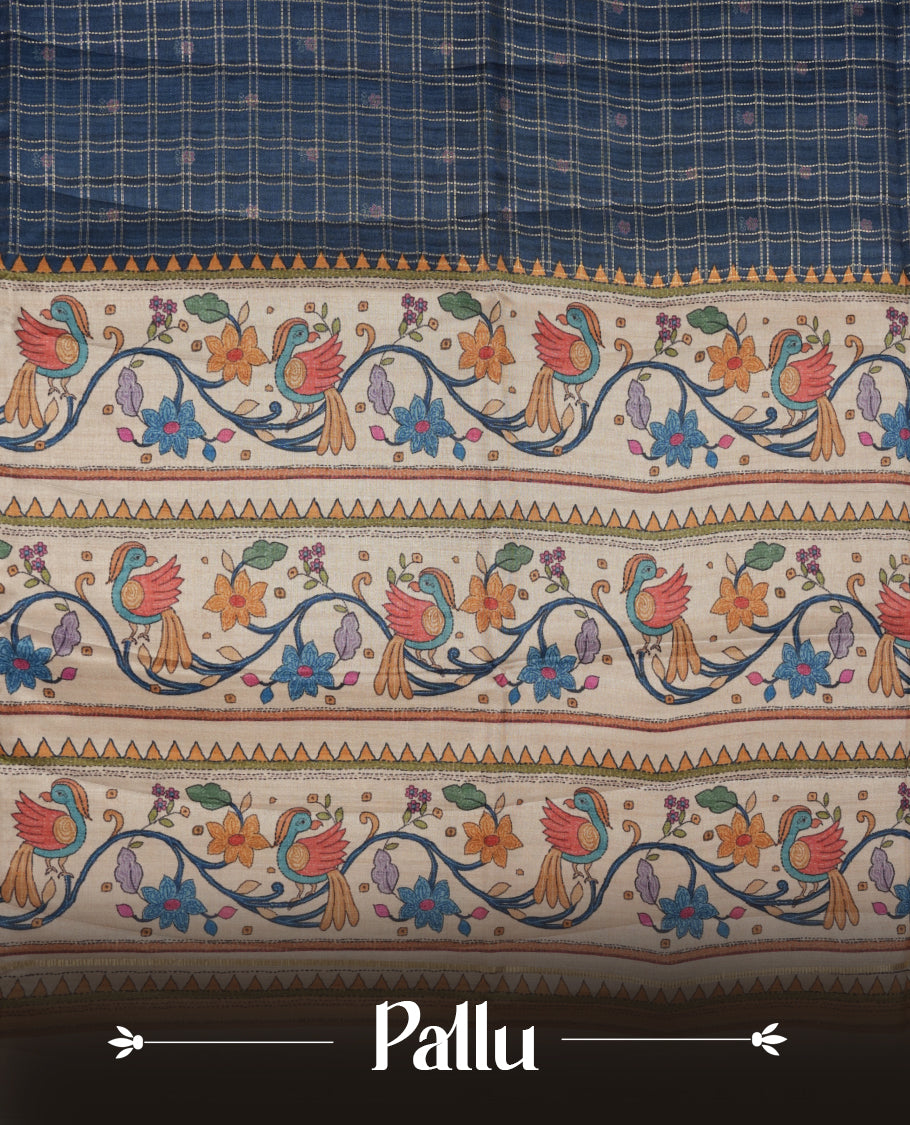 Dark blue colour semi tusser silk saree featuring gold zari check pattern with floral butti motifs, with contrast floral kodi & bird pattern and paired with matching blouse.