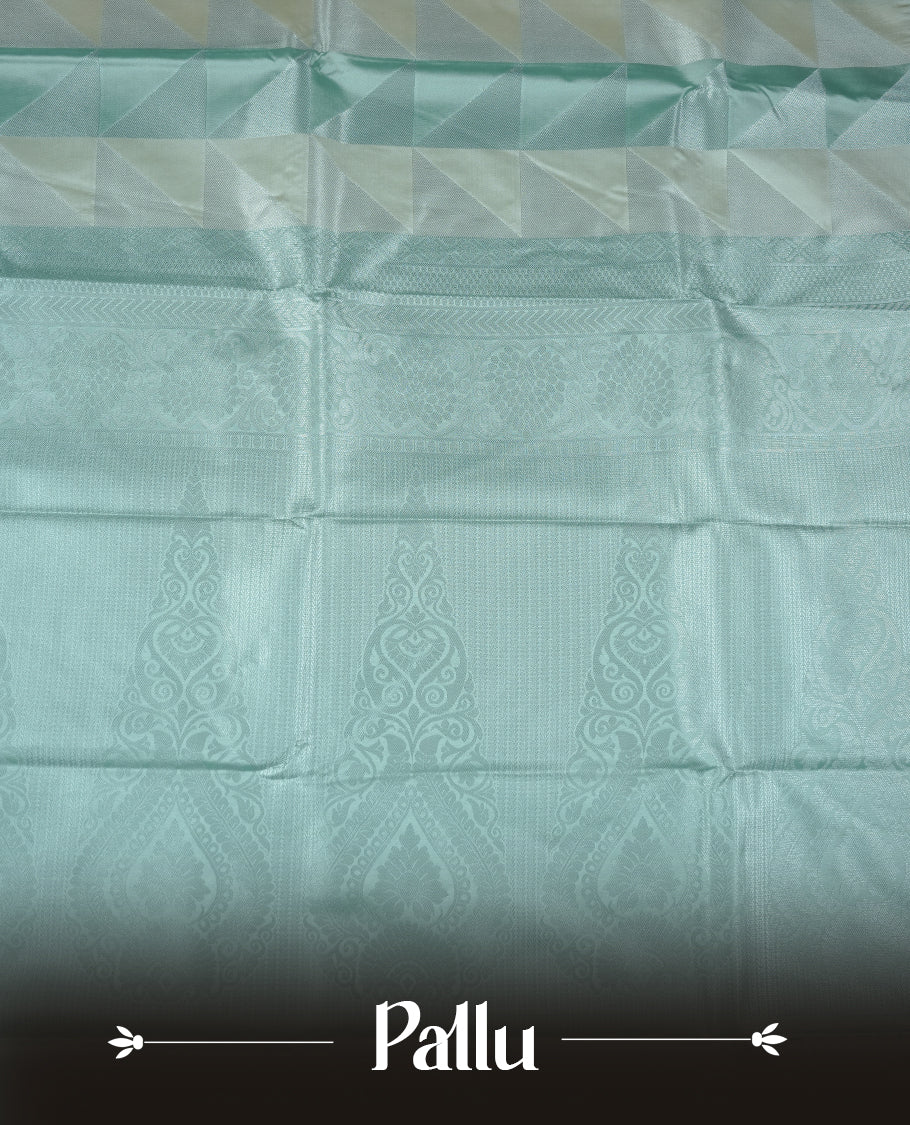Mint & cream colour semi soft silk saree featuring a silver zari patterned body, complemented by silver zari motifes on pallu & border and a matching blouse piece.