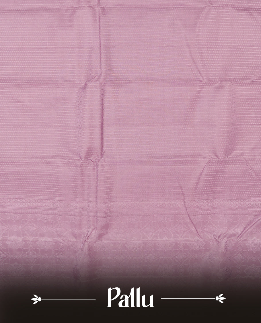 dusty lavender colour semi soft silk saree featuring a self coloured textured patterned body, complemented by self coloured  pallu & border and a matching blouse piece.