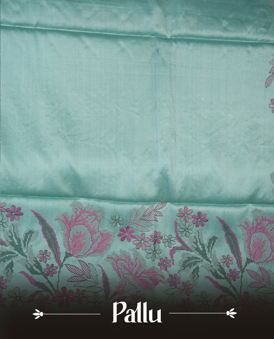 Pastel blue colour Pure tusser silk saree featuring finely crafted floral thread embroidery detailing on the border, pallu and with matching blouse piece.