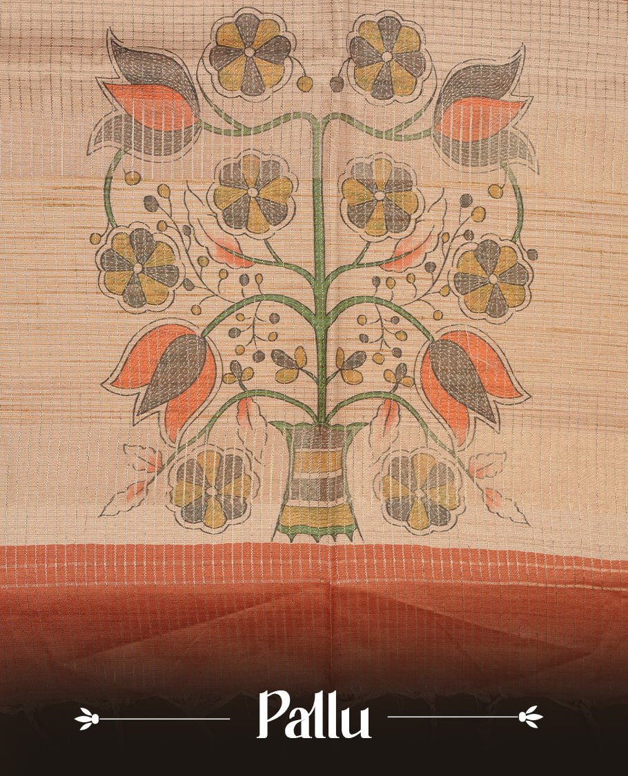 Wheat colour semi tussar silk saree featuring floral print and zari check pattern across body, contrast burnt orange colour border and pallu, paired with matching blouse piece.
