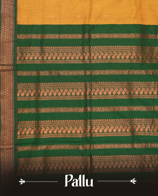 Mustard yellow colour Kalyani Cotton saree with woven zari motifs all over, paired with a contrasting green border and pallu intricately woven with copper zari & Comes with a matching blouse piece.