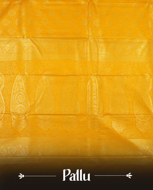 Yellow colour semi silk brocade saree featuring intricate Gold butta patterns across the body, complemented by a rich self colour woven border and pallu, paired with a matching blouse.