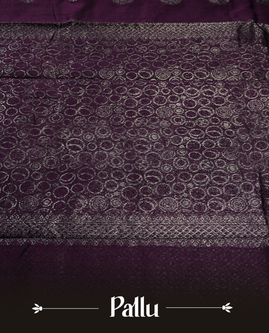 Grape colour silk cotton saree with shimmering silver zari border and intricately woven pallu, blending elegance and tradition. Paired with a matching blouse, perfect for festive celebrations and special occasions.