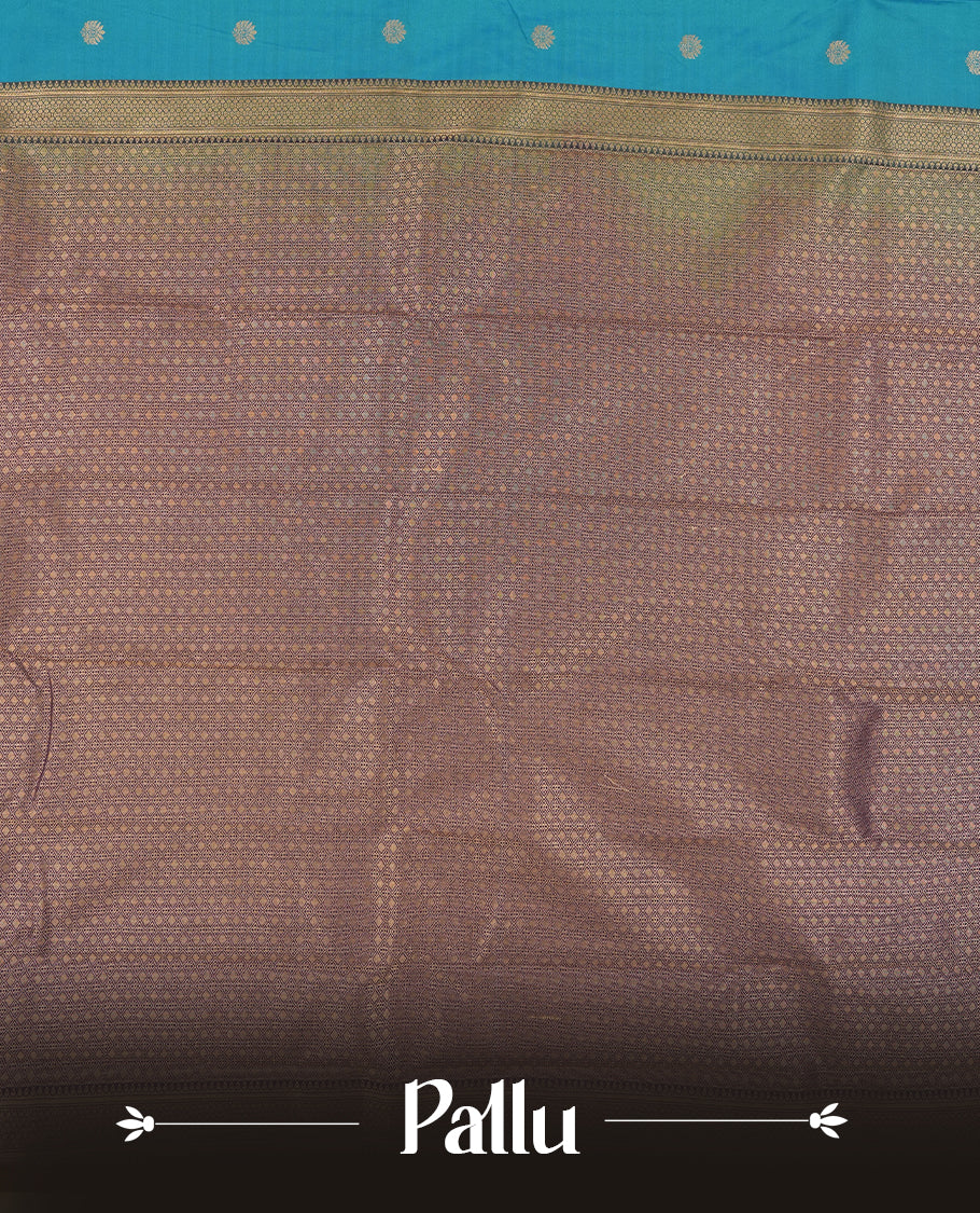 Teal Blue Colour Semi Silk Saree with Golden Peacock Butta Motifs, Contrasting Purple Golden Zari Pallu & Border, Traditional Leaf Designs, and Matching Blouse Piece