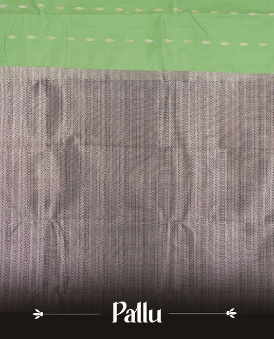 Jade green colour semi soft silk saree featuring a golden textured patterned body, complemented by contrast navy blue with silver zari motifes on pallu & border and a matching blouse piece.