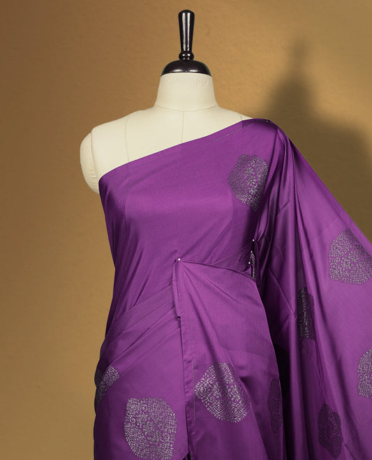 Purple colour semi soft silk saree, beautifully designed with self woven motifs & The look is enhanced by a rich contrast green border and pallu, paired with a matching blouse.
