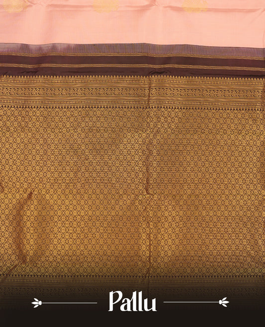 Baby pink colour Vasundhara silk saree adorned with all-over gold two head mayil motifs on the body, complemented by a  contrast brown colour with gold traditional border and paired with a matching blouse piece.