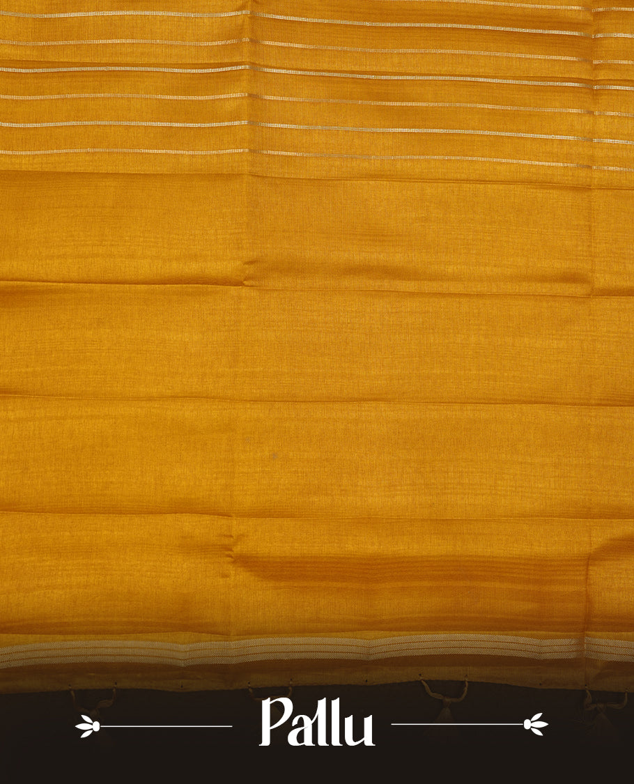 Mustard colour semi tussar silk saree highlights gold and silver zari stripes across body,  border, pallu and paired with matching blouse piece.