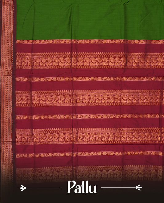 Deep forest green colour Kalyani Cotton saree with rich maroon border and pallu, featuring copper zari peacock motifs and intricate weaving & Includes a matching blouse piece.