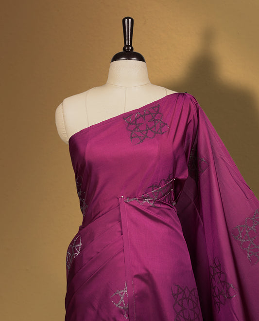 Wine colour semi soft silk saree, adorned with subtle self woven motifs on the body & The design is elevated with an elegant zari border and pallu, paired with a matching blouse.