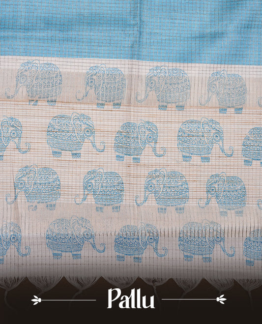 Sky-blue and off-white colour semi tussar silk saree featuring an all-over elephant motif print across the body, complemented by a contrasting blue pallu and border, and paired with a matching blouse piece.