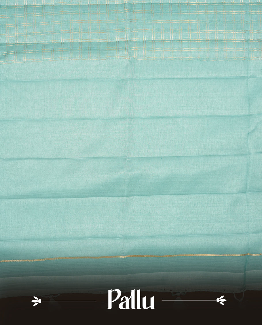Powder blue colour semi Tussar saree highlights gold zari check pattern across body,  border, pallu and paired with matching blouse piece.