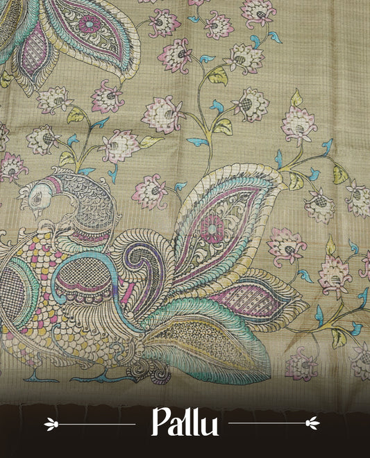 Olive Green colour semi tussar silk saree, featuring an intricate multicolour peacock motif on the pallu, a subtle self-textured plain body, and a floral-printed matching blouse.