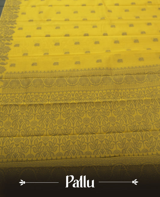 Chrome yellow colour silk cotton saree featuring elegant floral zari motifs on the body, complemented by a rich contrast dark plain grey border and pallu with traditional woven detailing & Comes with a matching blouse piece.