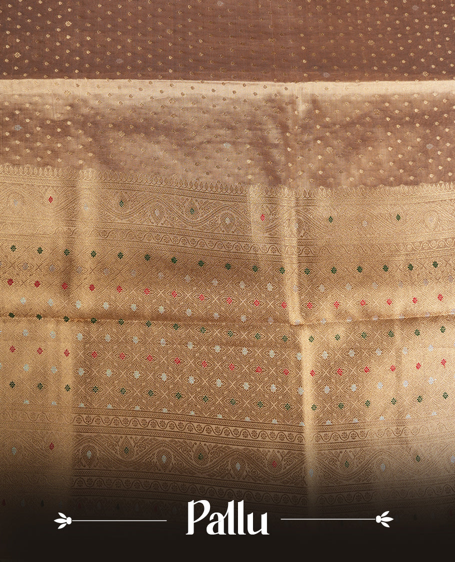 Gold colour tissue banaras silk saree featuring antique gold zari motifs on the body with rich traditional zari border and pallu, paired with a matching blouse piece.