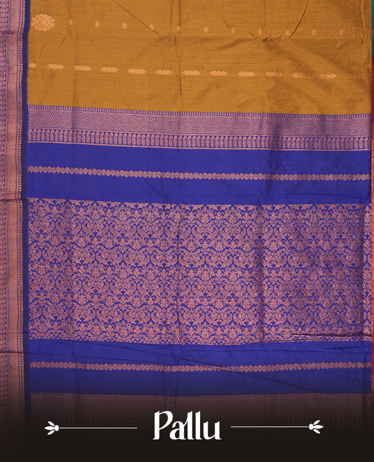 Dark golden yellow and royal blue Kalyani cotton saree featuring delicate zari butta work on the body, highlighted with an elegant contrast zari woven border & Paired with a matching blouse.