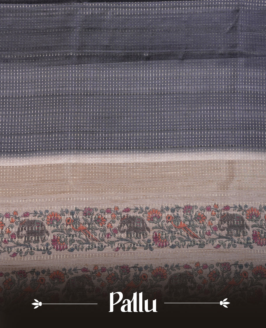 Charcoal black colour tussar saree featuring golden zari dot stripped pattern on the body, complemented by a contrast cream colour mutlicolour floral kodi & animal print on border & pallu, paired with a matching blouse.