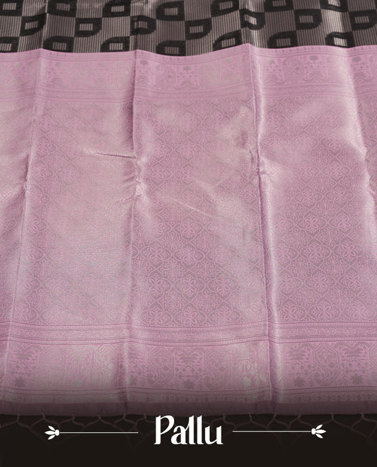 Black colour semi silk saree adorned with silver zari designs on the body, complemented by a contrasting light pink border and pallu, and paired with a matching blouse piece