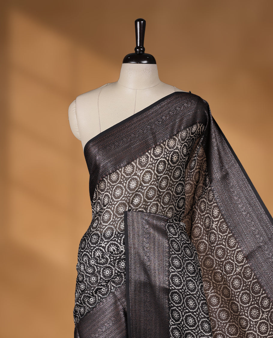 Black colour chanderi silk saree with Floral block print On body, compilmented by self colour border with antique zari pattern and a matching blouse.