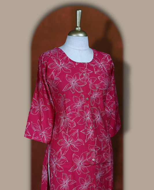 Magenta colour coord set adorned with all over beige colour floral prints, featuring a straight cut kurta with round neckline and 3/4th sleeves, paired with matching bottoms.