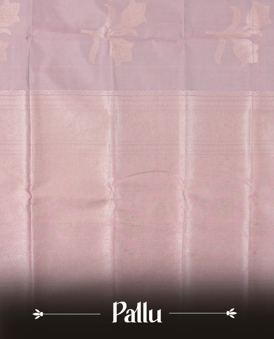 Dusty Lilac Semi Silk Saree with Subtle Zari Butta Motifs, Matching Pastel Lilac Zari Woven Pallu and Border with Intricate Floral Patterns and Tassels, Paired with Coordinated Blouse Piece