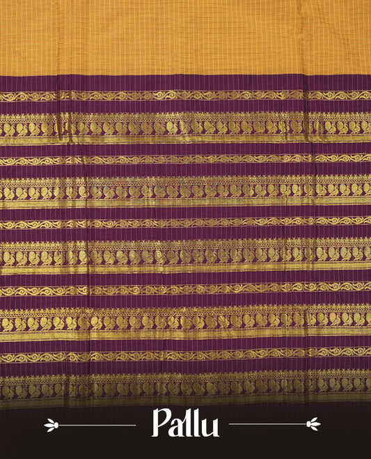 Mustard Yellow coloured mixed Kalyani cotton saree featuring golden zari checks on the body, complemented by a dark purple coloured border and pallu adorned with golden zari patterns, Paired with a matching blouse.