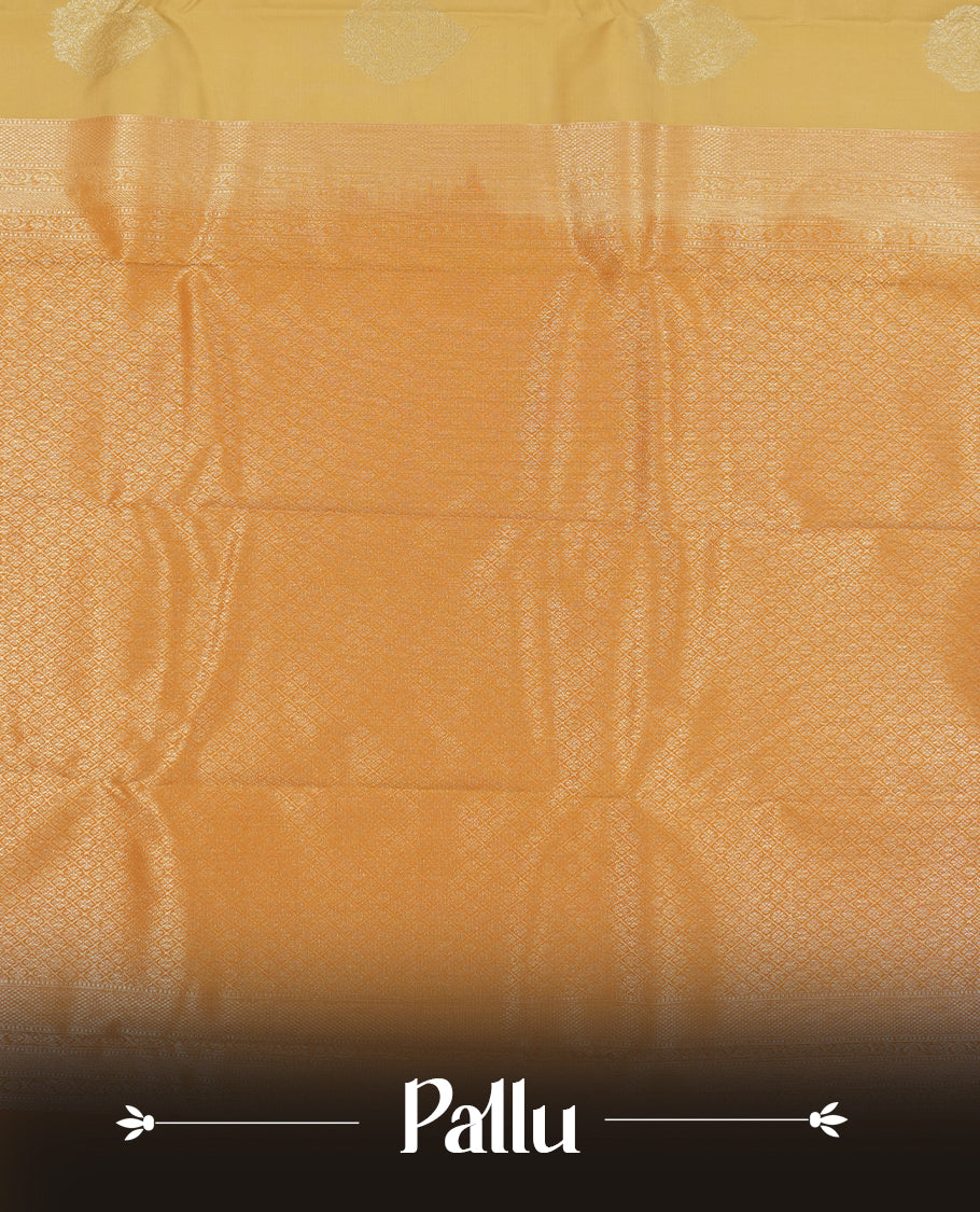 Muted yellow colour semi soft silk saree featuring a gold zari motifs on body, complemented by contrast mustard colour with gold traditional  pallu & border and a matching blouse piece.