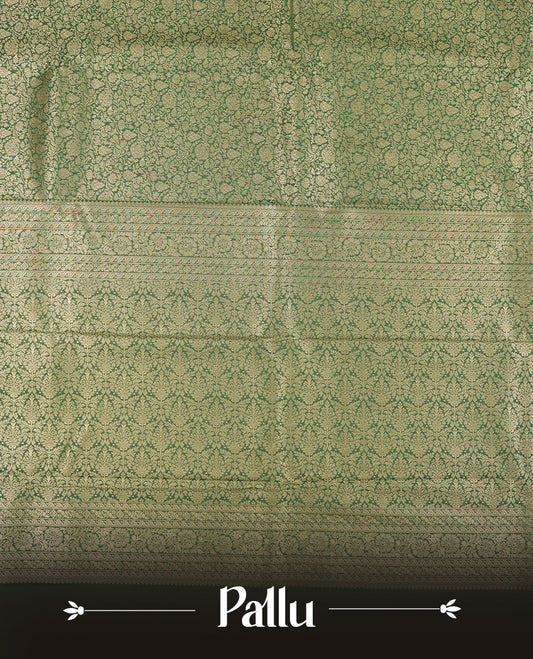 Green colour semi silk brocade saree featuring intricate Gold Floral kodi patterns across the body, complemented by a rich self colour woven border and pallu, paired with a matching blouse.