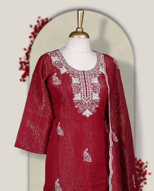 Maroon churidar set featuring elegant white thread embroidery on the neckline, sleeves, and scattered motifs across the body, Paired with a matching embroidered dupatta, this ensemble radiates graceful charm and festive appeal.