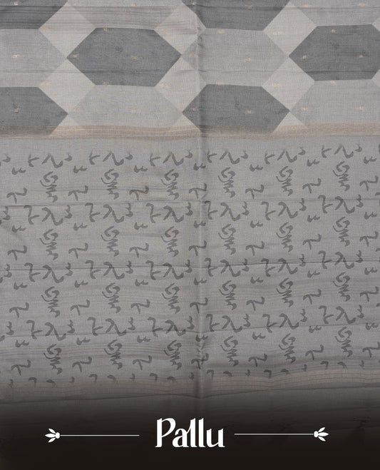 Gray colour semi tusser silk saree featuring geometric print pattern across body, gold zari border with style motifs and paired with matching blouse.