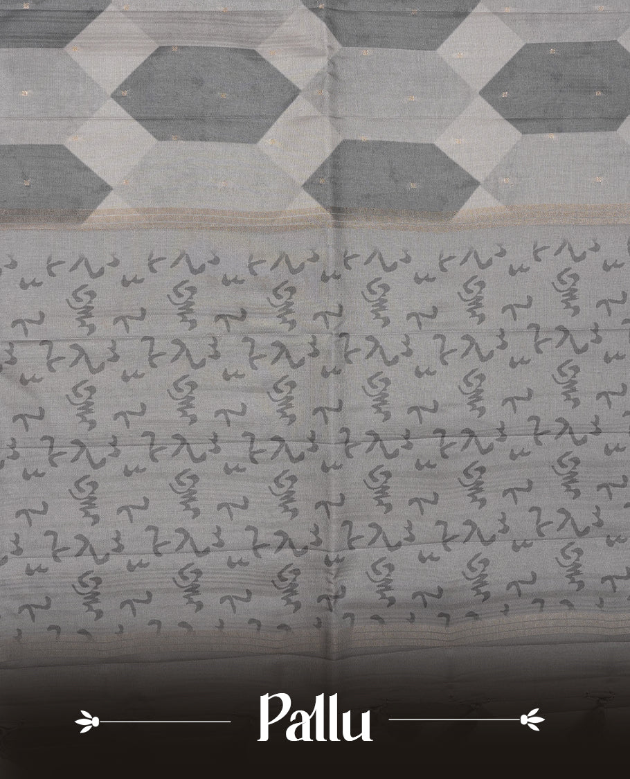 Gray colour semi tusser silk saree featuring geometric print pattern across body, gold zari border with style motifs and paired with matching blouse.